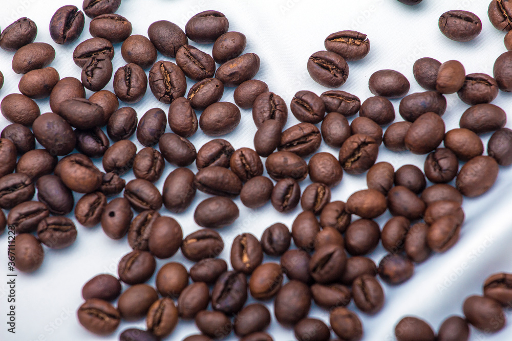 Holding brown coffee beans Holding brown coffee beans