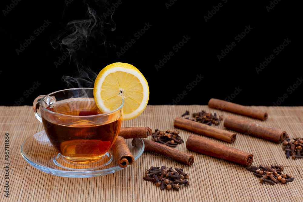 hot cinnamon tea and clove grains on tree table hot cinnamon tea and clove grains on tree table