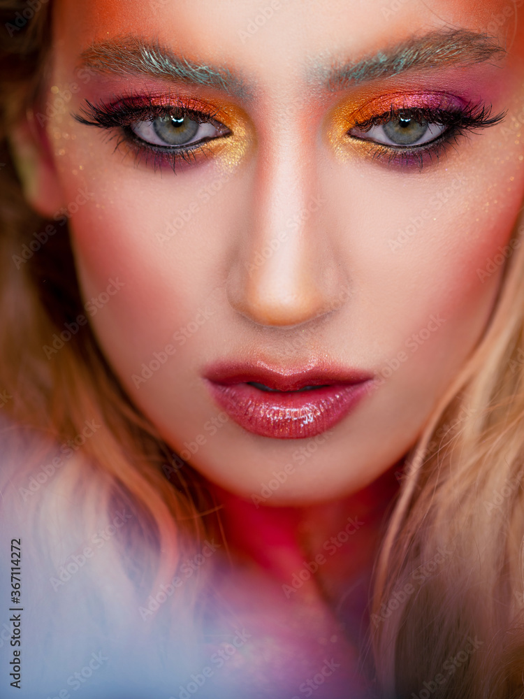 Bright makeup and face art, close-up portrait. Creative makeup,