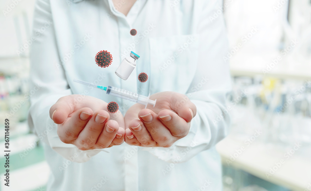 Nurse shows the injection and the corona viruses concept. Lab is in the background Nurse shows the injection and the corona viruses concept. Lab is in the background