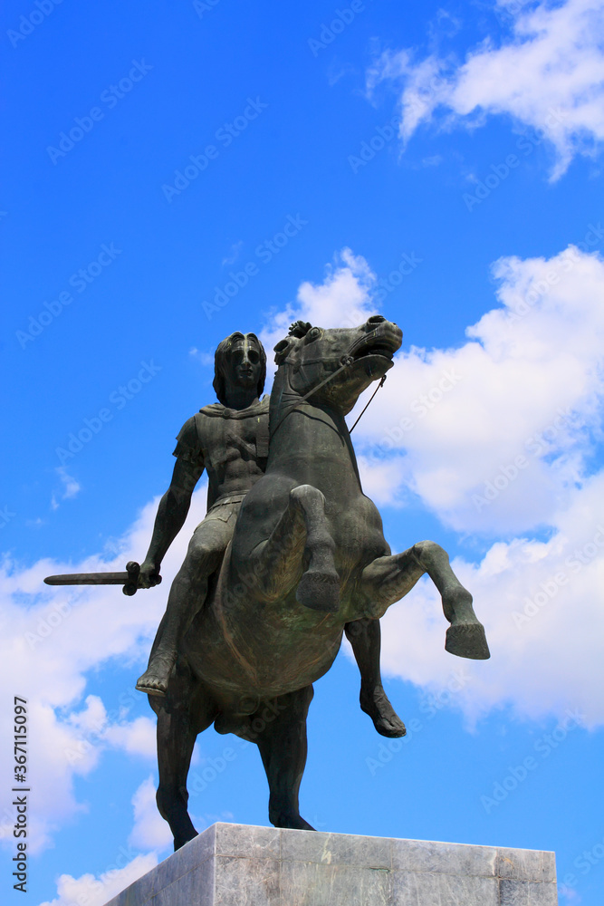 Alexander The Great statue against blue sky and clouds 