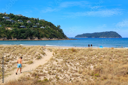 Pauanui Beach on the Coromandel Peninsula, New Zealand. To the left is Mount Paku and the town of Tairua. In the background is Shoe Island
