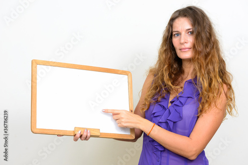 Portrait of young beautiful businesswoman with curly blond hair