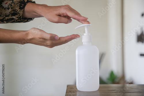 Woman applying hand sanitizer during Coronavirus and flu outbreak. Virus and illness protection. Hands disinfection as prevention of Coronavirus disease. 