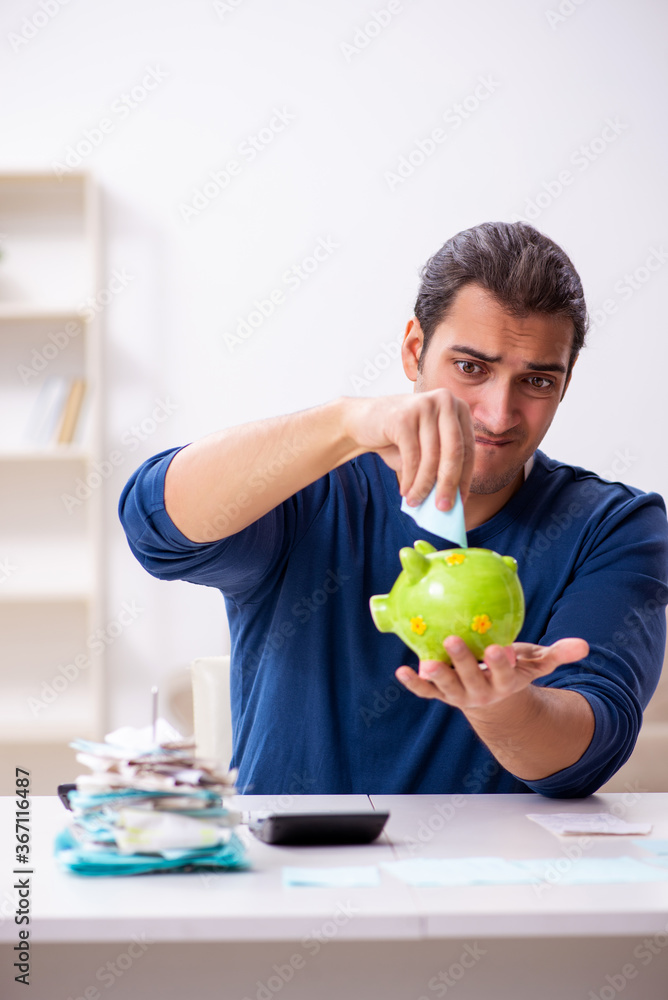 Fototapeta premium Young man in budget planning concept