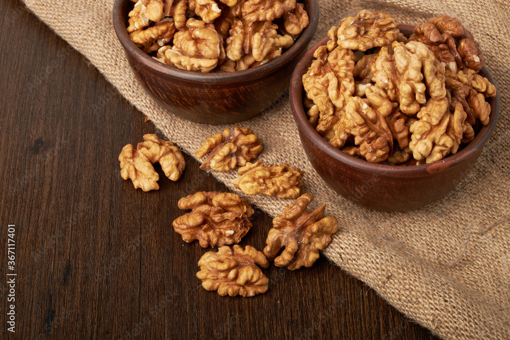 Walnut kernels on a wooden background. Walnut kernels on a wooden background.