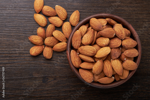 Walnut kernels on a wooden background.Almonds, walnuts and hazelnuts in bowls on a wooden background