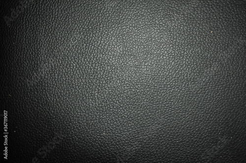 Dark black leather with brown spots texture background surface. Image for background. Selective focus applied.