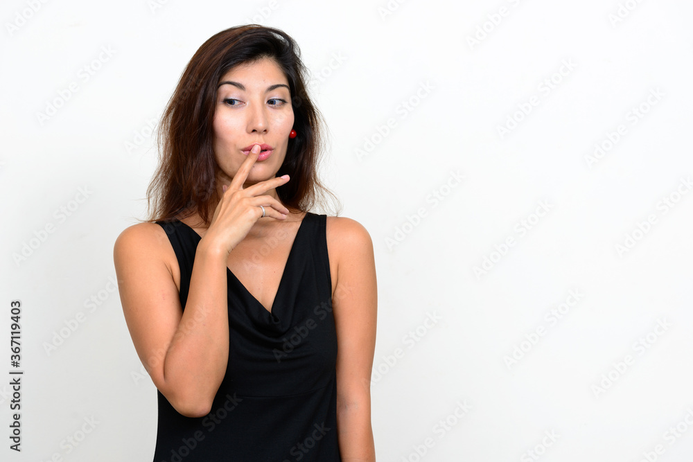 Portrait of young beautiful woman with finger on lips Portrait of young beautiful woman with finger on lips