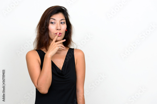 Portrait of young beautiful woman with finger on lips