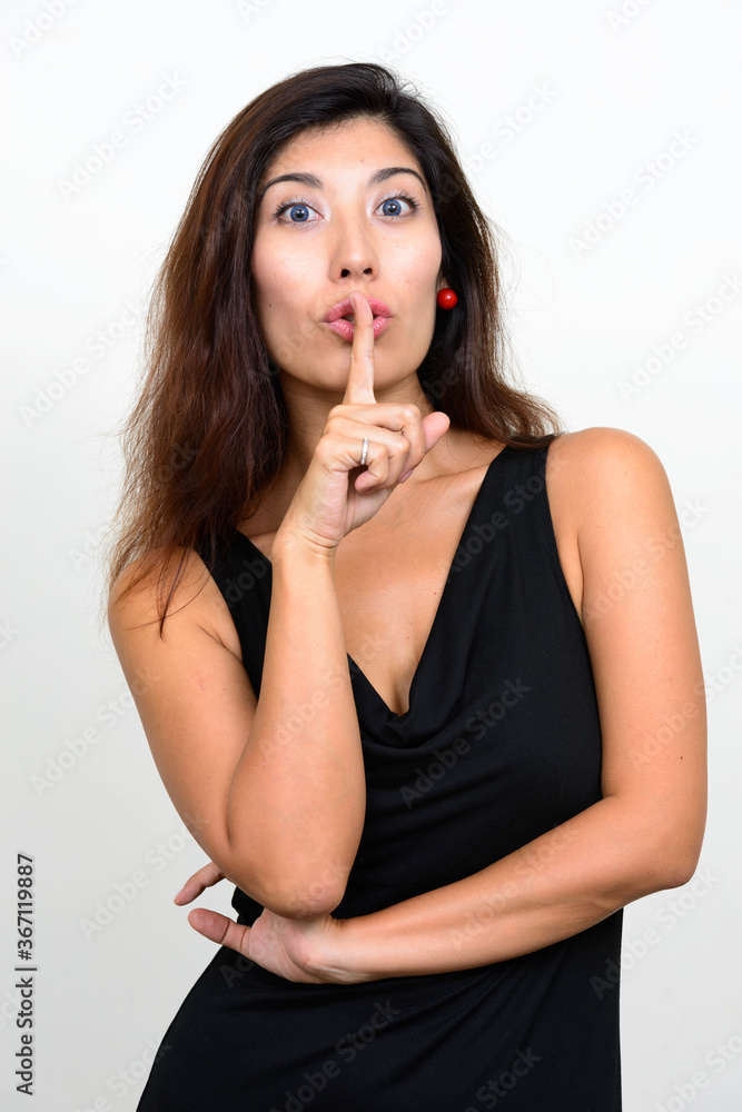 Portrait of young beautiful woman with finger on lips Portrait of young beautiful woman with finger on lips