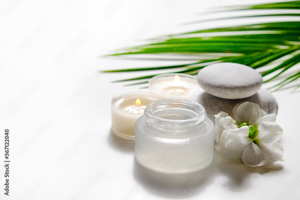 Moisturizing care skincare face cream for healing complicated troubled skin type in an open jar with visible texture. Copy space, close up, background, flat lay, top view. Coconut leaf decoration.