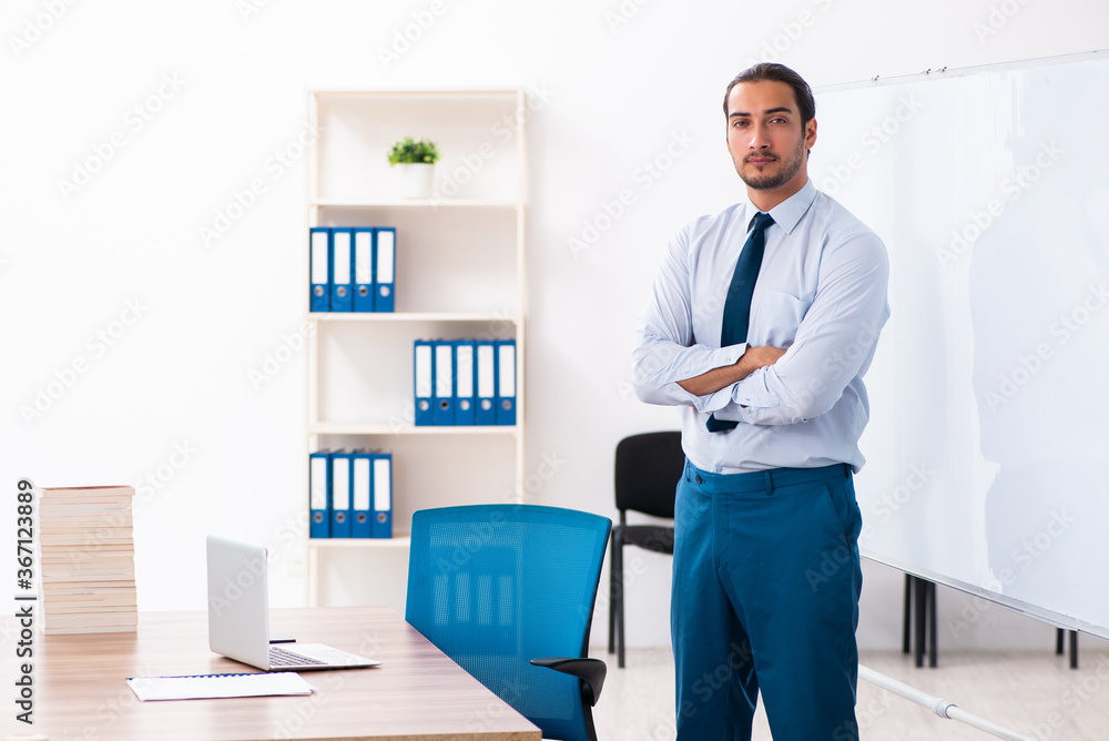 Young male employee in business presentation concept Young male employee in business presentation concept
