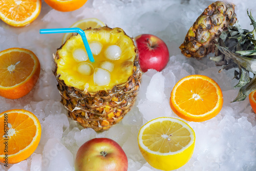 Fototapeta Naklejka Na Ścianę i Meble -  Fruit cocktail with pineapple,ice cubes and citrus on the ice