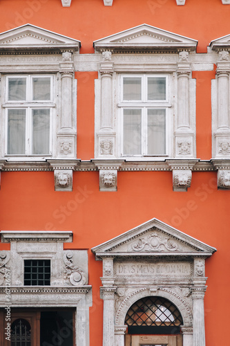 Orange and white facade with windows and old portal of a house with aphorisms, Hepner's townhouse. Inscription DEUS MEUS ET OMNIA means God is my all. Renaissance architecture in Lviv, Ukraine. photo