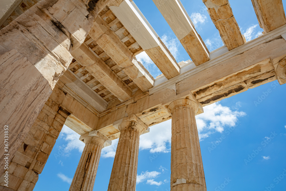 Athens, Greece. Propylaea in the Acropolis, monumental gate roof, blue cloudy sky Athens, Greece. Propylaea in the Acropolis, monumental gate roof, blue cloudy sky