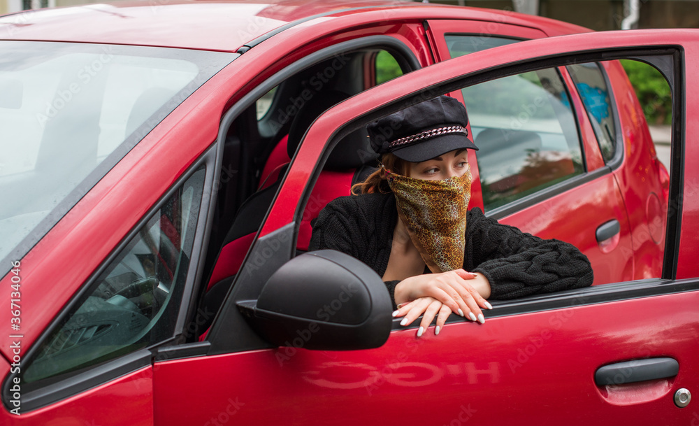 Social distance in citizens life, woman in a car, on the street Social distance in citizens life, woman in a car, on the street