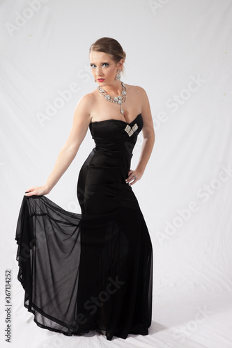 Lovely woman in a black dress with her hand on her hip