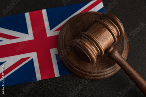 Judge Gavel and flag of United Kingdom. Law and justice in UK. Violation of rights and freedoms in Britain photo