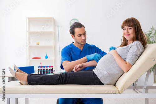 Young pregnant woman in blood transfusion concept