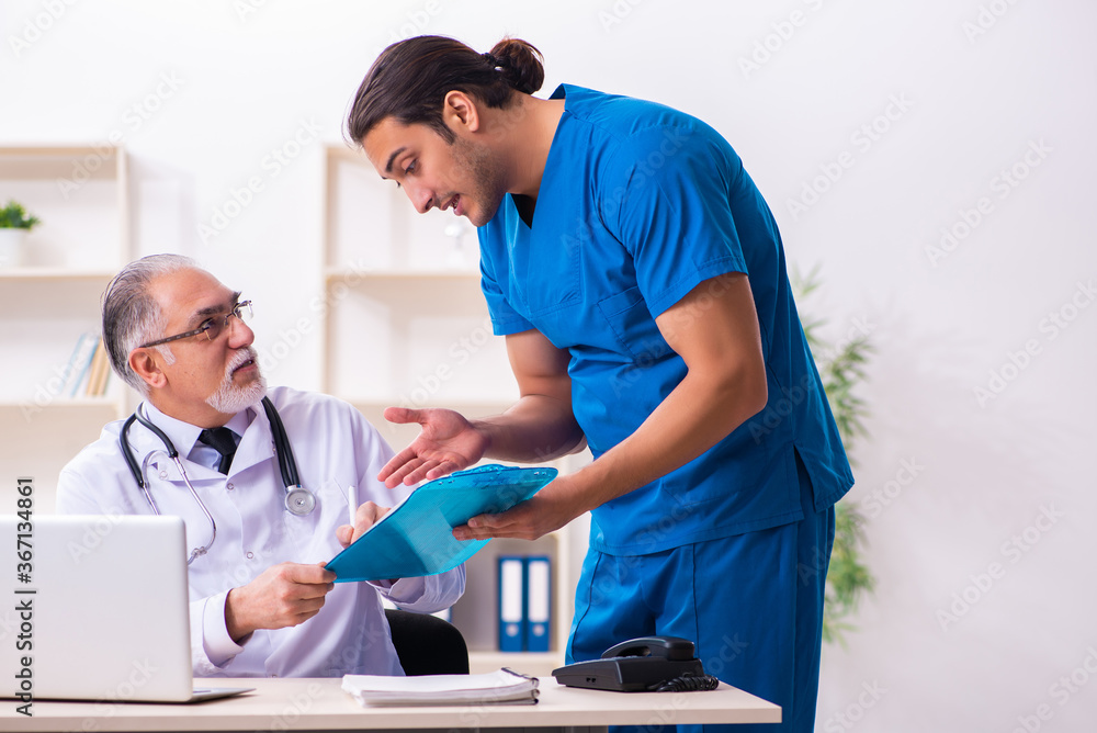 Fototapeta premium Two male doctors working in the clinic
