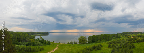 thunderstorm over forest and lake in autumn.
