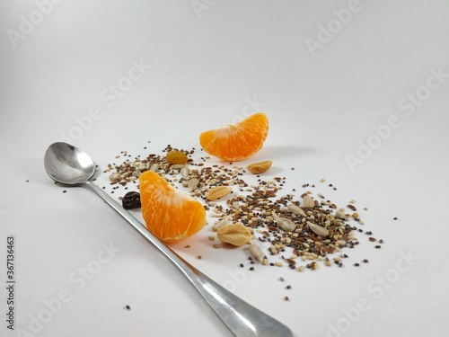  seeds and dried fruits scattered on a white background