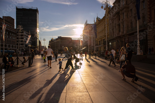 Zagreb/Croatia-July 18th, 2020: Beautiful sunset over main Zagreb square, full of people having fun and gathering around street performers under the summer sun