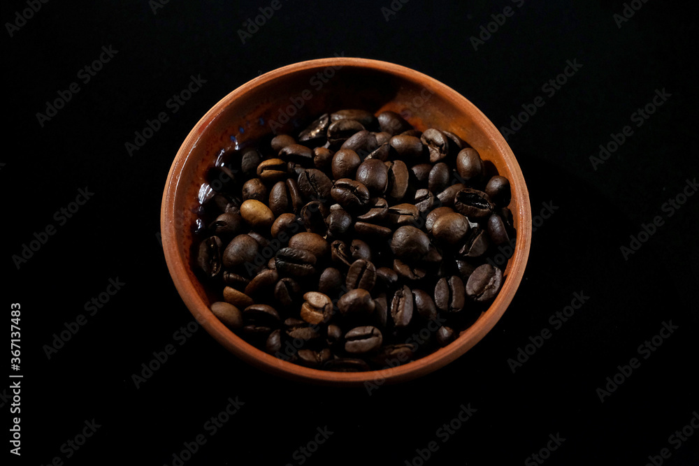 Fototapeta premium coffee in a clay cup on black velvet