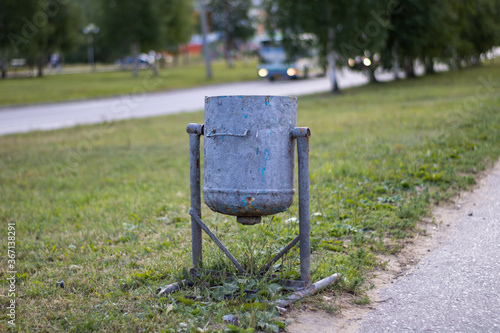 Very old street trash can. Street trash can. photo