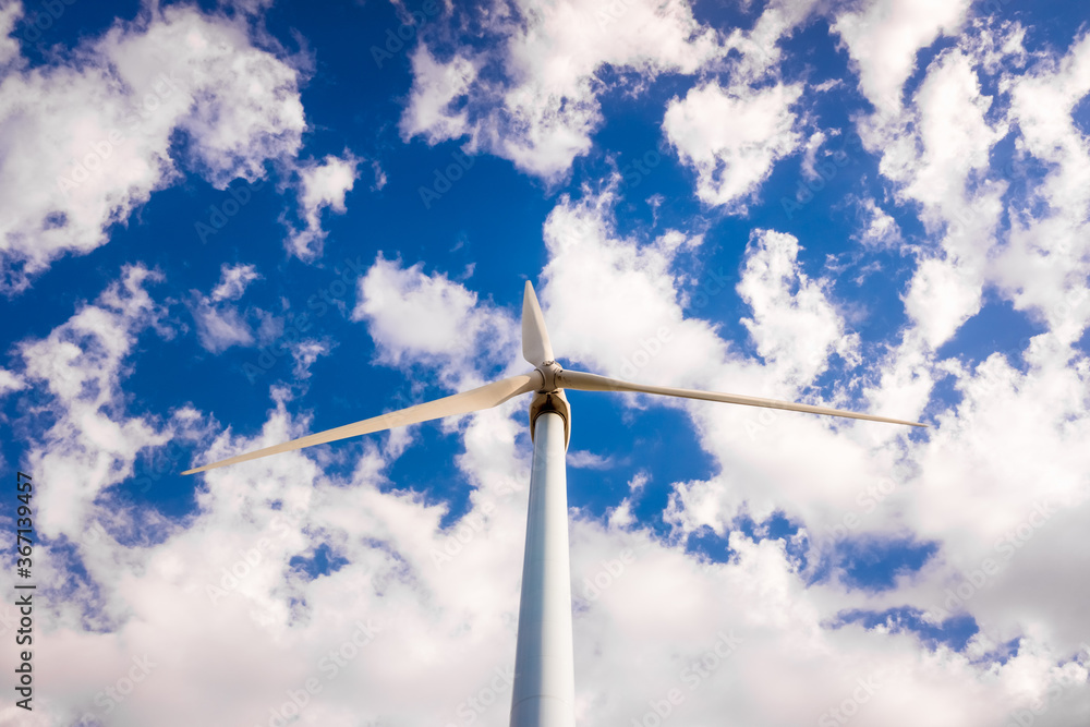 High modern windmills spinning to generate electricity viewed from below. High modern windmills spinning to generate electricity viewed from below.