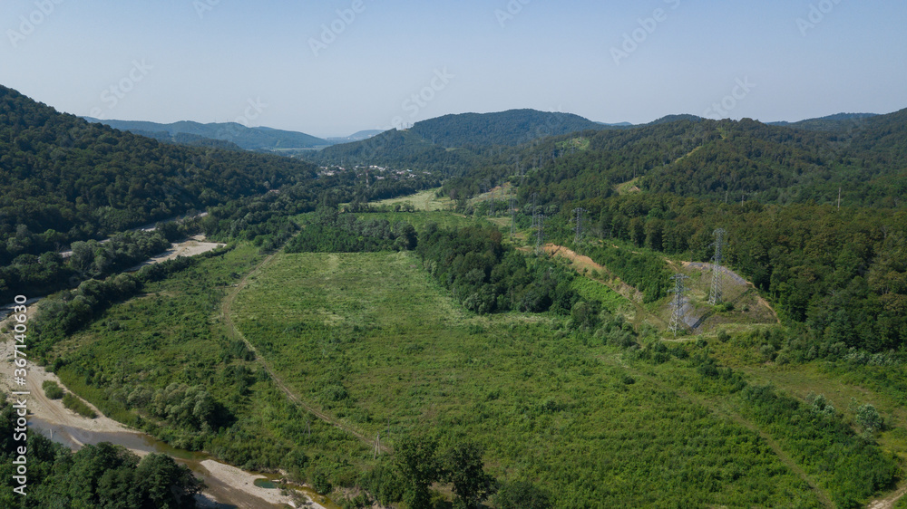 Aerial view from above of curve highway road with a car with green forest in Russia