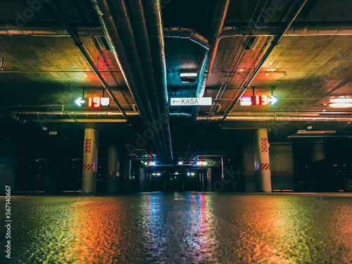 empty underground office car parking with neon colorful lights in the night photo