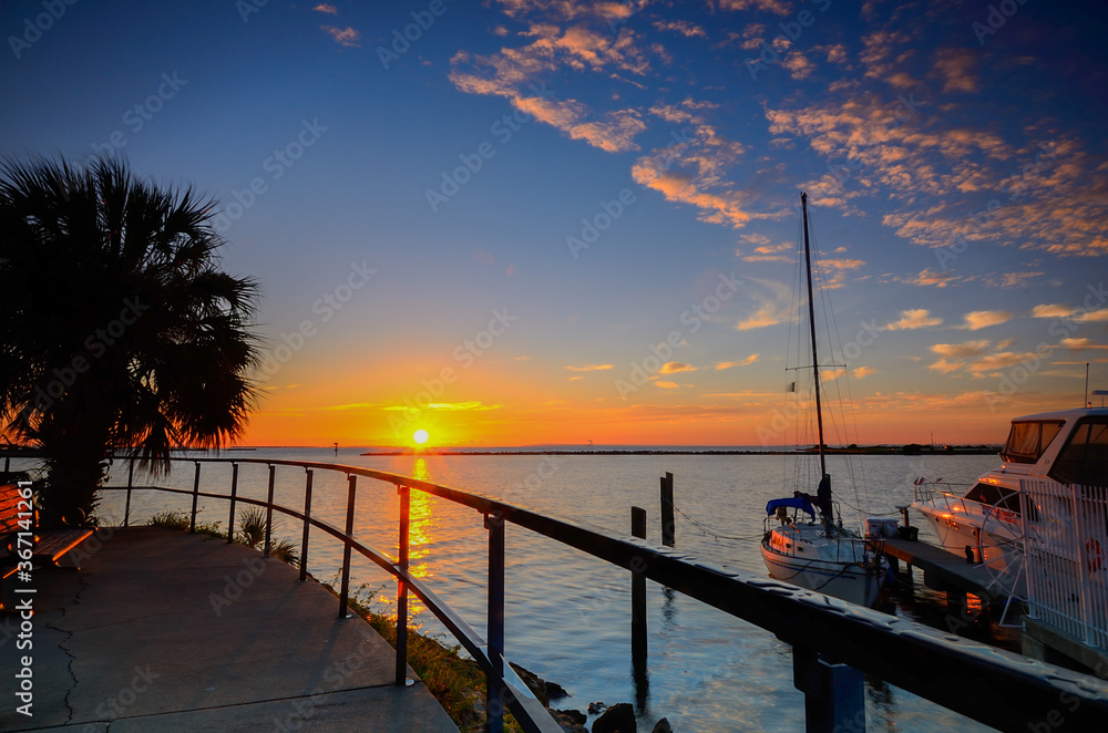 Fototapeta premium Sunrise moment at a marina in the west of Florida. Soft Focus due to Long Exposure