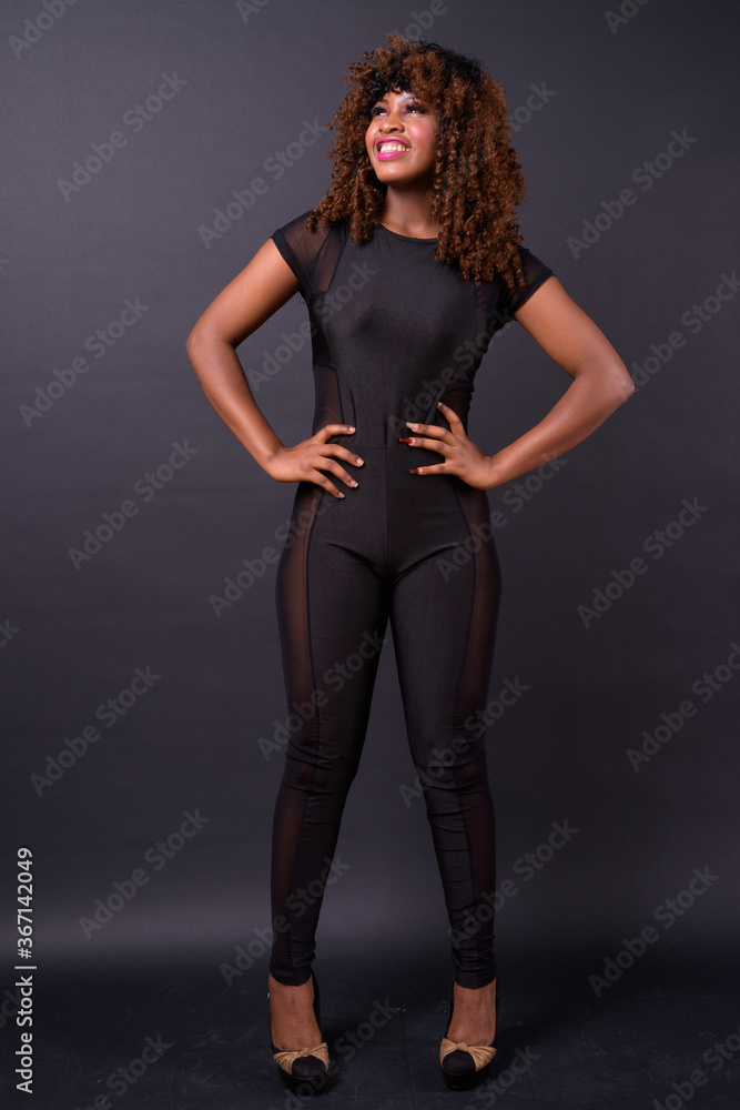 Young beautiful African woman against black background Young beautiful African woman against black background