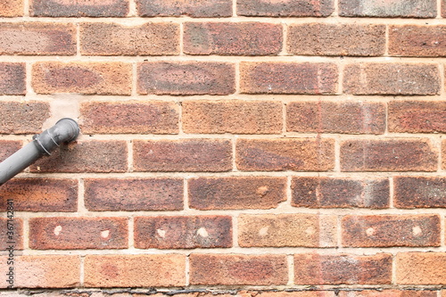 close up house wall that has had the cavity wall insulation holes filled in