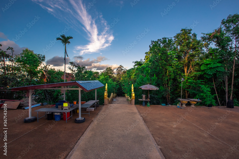 Obraz premium Background of Wat Pha Tak Suea, which is located on a mountain and offers views of neighboring countries such as Laos, the Mekong River, beautiful pagodas and churches for tourists to make merit.