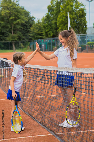 Tennis kids. Children give five each other.