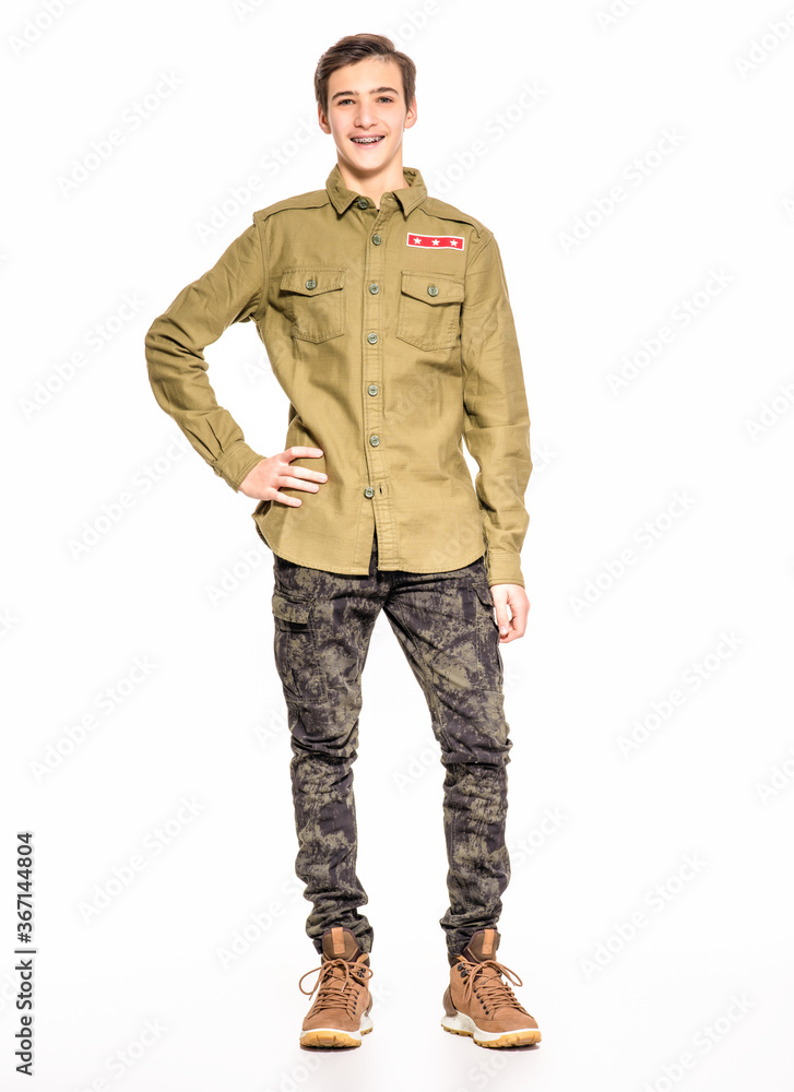 Smiling young man in camouflage clothing. Happy Conscript in camouflage. Cheerful rookie in army clothes. Teenager in khaki military clothing. Smiling young man in camouflage clothing. Happy Conscript in camouflage. Cheerful rookie in army clothes. Teenager in khaki military clothing.