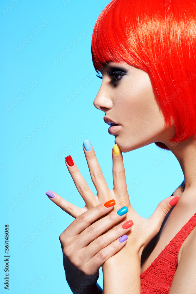 Profile portrait  of a fashion model with  red hairs and multicolor nails. - obrazy, fototapety, plakaty 