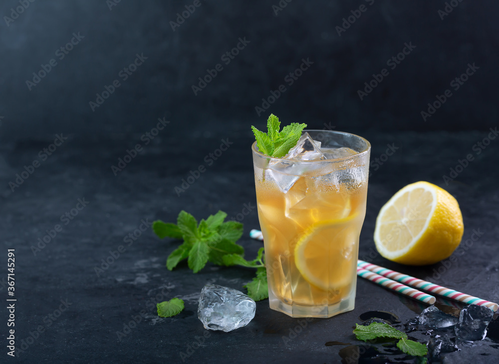 Lemon ice tea on dark background with mint and ice Lemon ice tea on dark background with mint and ice