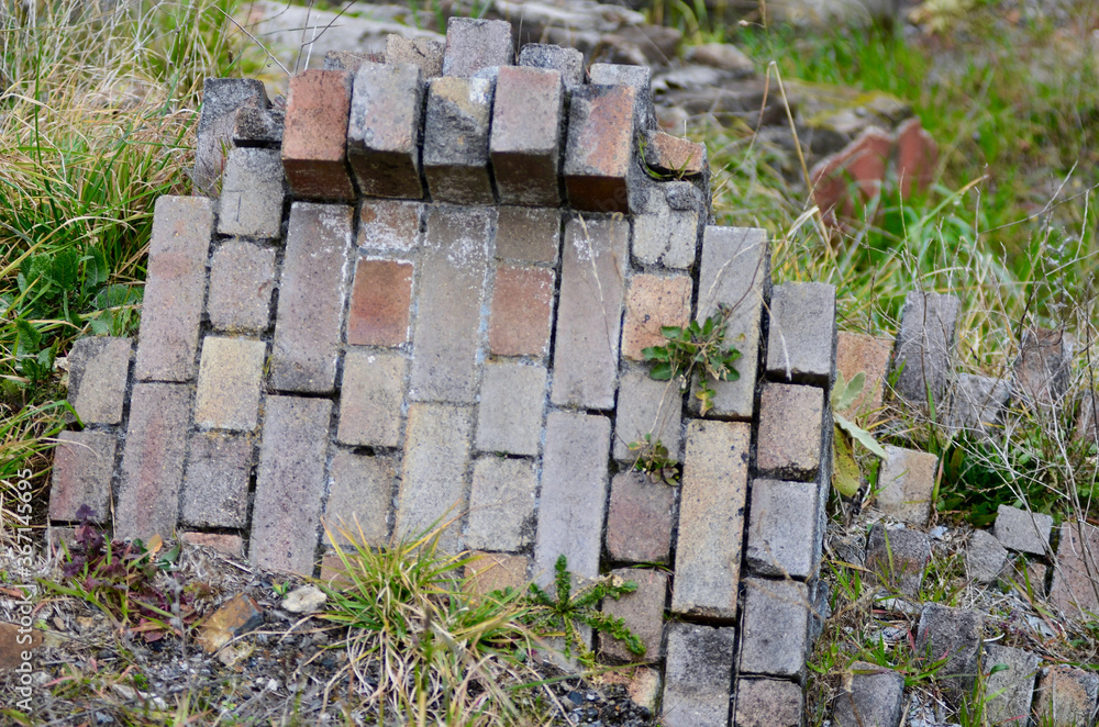 Fallen brickworks on the grass Fallen brickworks on the grass