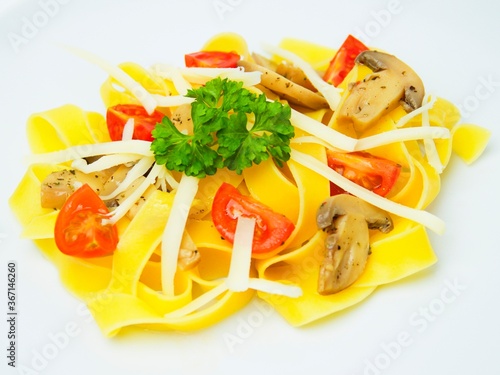 
Fresh Italian pasta Papardele with tomatoes and mushrooms on a white background. photo