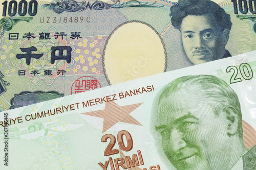 A macro image of a Japanese thousand yen note paired up with a green, twenty Turkish lira bank note. Shot close up in macro.