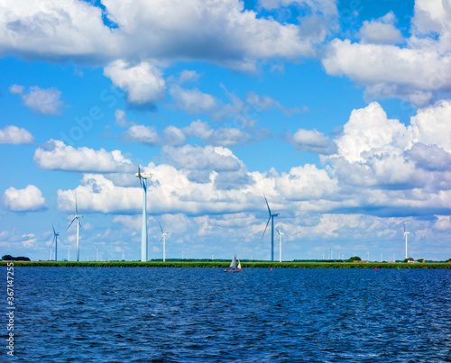 Landscape with former sea and new land and windmills in the Netherlands 