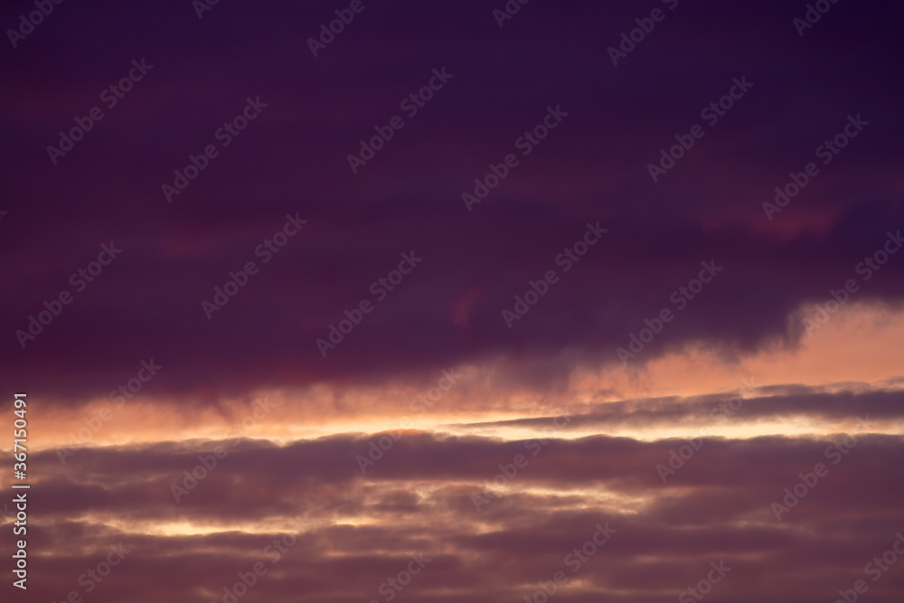 Dark purple and vanilla clouds. Sunset. Beautiful natural background.
