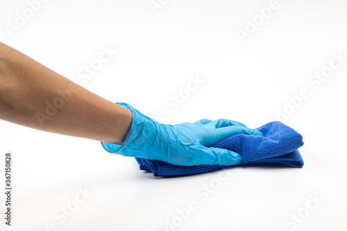 Close up of hands in rubber protective blue gloves cleaning the blue surface with a rag. Home, housekeeping concept