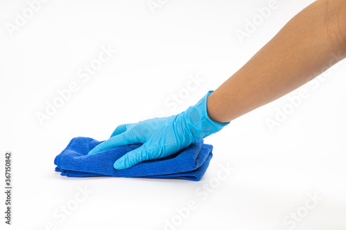 Close up of hands in rubber protective blue gloves cleaning the blue surface with a rag. Home, housekeeping concept