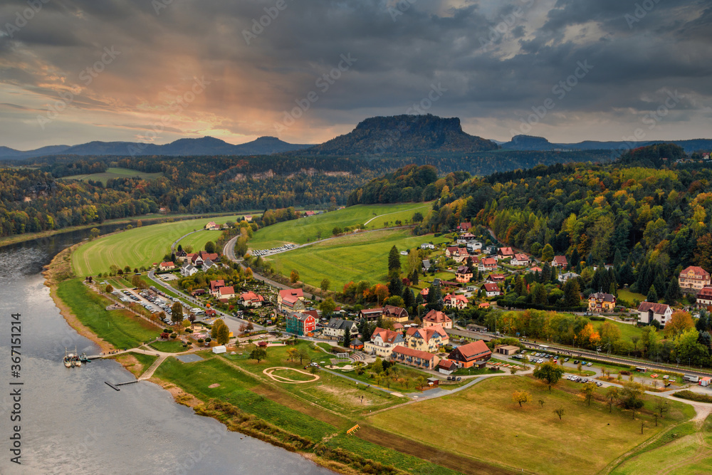 Fototapeta premium Amazing autumn landscape in Saxon Switzerland National Park. View of exposed sandstone rocks and forest hilly at sunset.Germany. Europe. Concept of outdoor recreation in natural settings out of town.