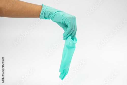 A woman with medical gloves in her hand on a white background